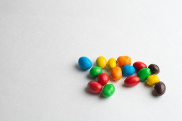 Colorful chocolate candies on the white background