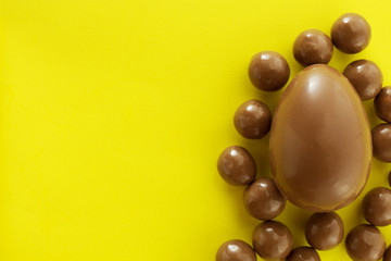Chocolate eggs in bird nest , Easter holiday decorations , Easter concept background. Eggs hunt.
