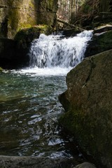mountain waterfall among big stones