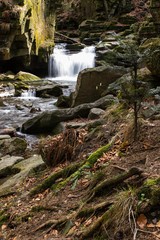Fototapeta premium mountain waterfall among big stones