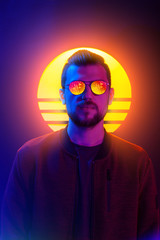 80s sci-fi futuristic fashion poster style violet neon. Retro wave synth vapor wave portrait of a young man in sunglasses.