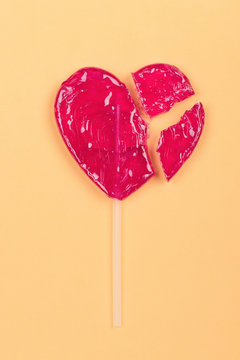 Broken Lollipop Candy Heart Love Shape On Yellow Background