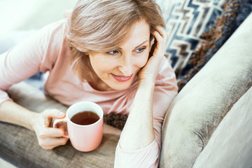 Attractive middle aged woman relaxing at home