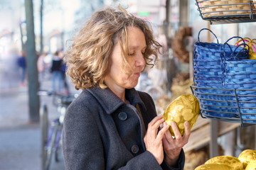 Attractive mature woman looking at an Easter egg