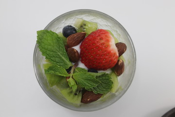 Kiwi Fruit with Yogurt , Topped with Red Strawberry and Mint on White Background