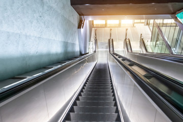 Escalators long staircase descending into the subway, urban transport infrastructure.