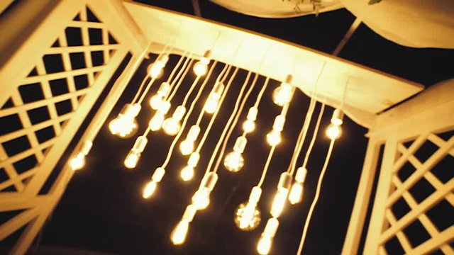 Lamps close up. Wedding garlands that glow on the arch. Vespers Wedding Ceremony