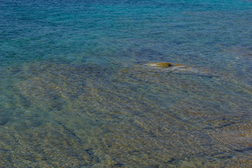 shallow transparent water deep and stone blue perspective surface natural reservoir wallpaper background pattern with empty copy space for your text or inscription 