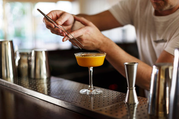 waiter finishing a cocktail decoration 
