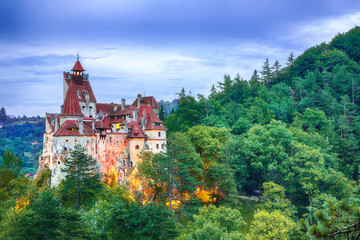 Landscape with medieval Bran castle known for the myth of Dracula at sunset