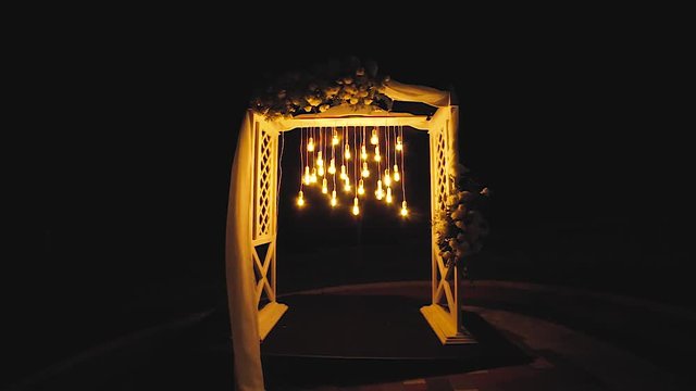 Lamps close up. Wedding garlands that glow on the arch. Vespers Wedding Ceremony