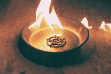 Old pentagram burning in flames
