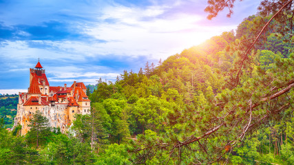 Landscape with medieval Bran castle known for the myth of Dracula at sunset