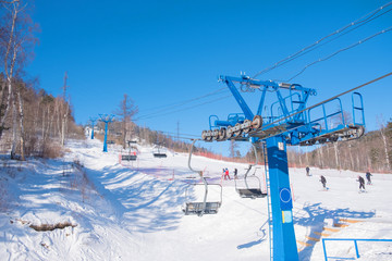 Fototapeta na wymiar Ski hill lift. Transportation for skiing on snow hill.