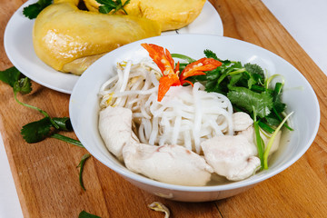 Traditional oriental cuisine of  Vietnam. Soup pho ga with rice noodles, chicken, pepper, wheat germ, greens