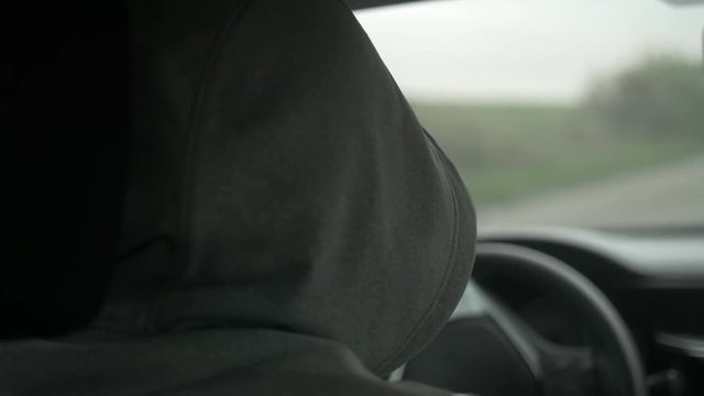 Shot of the men driving a car in countryside.