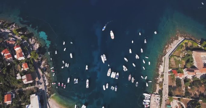 Top down view of Hvar island harbor, tilt up reveal Adriatic sea