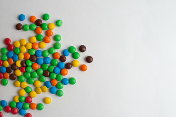 Colorful chocolate candies on the white background