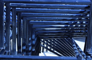 abstract view of blue wrought iron beds placed in the village field