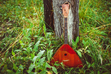 Folk musical instrument balalaika on wooden background