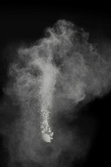 powder explosion with smoke on black background