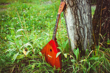 Folk musical instrument balalaika on wooden background