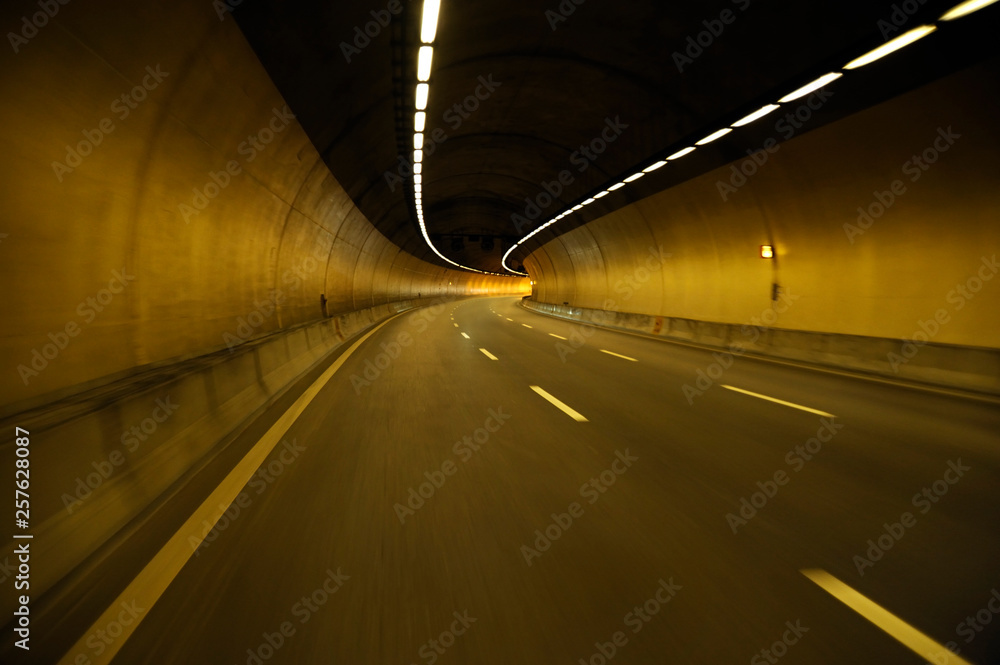 Wall mural empty highway road at night tunnel with speed motion blur