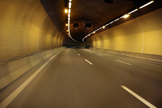 Fototapeta Empty highway road at night tunnel with speed motion blur