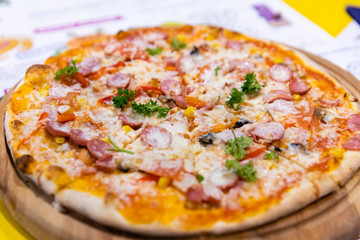 Hot pizza on the table in restaurant