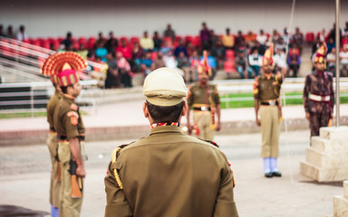 Portrait of an unrecognizable indian policeman standing. Rear view.