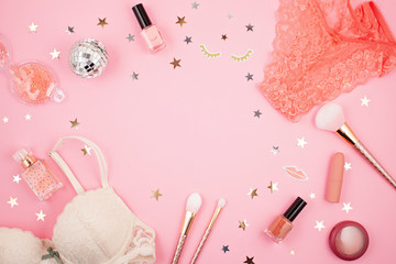 Flat lay with glamour girls accessories over pink background