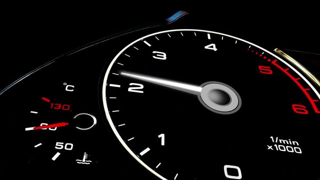 White speedometer close up illuminated at night - accelerating and decelerating. 4k 