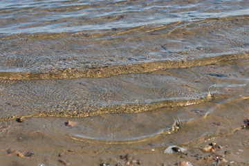 transparent water in the river, wave onto the beach