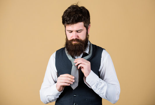 Different Ways Of Tying Necktie Knots. Art Of Manliness. How To Tie Necktie. Start With Your Collar Up And The Tie Around Your Neck. How To Tie Simple Knot. Man Bearded Hipster Try To Make Knot