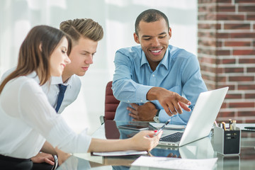 employees talking to a customer sitting at the Desk