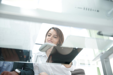 bottom view.young business woman reading a working paper