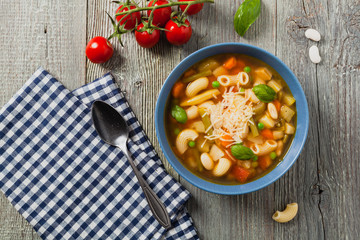Minestrone soup with pasta and cheese.