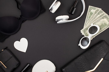 Black and white woman accessories, lingerie, handbag and money flat lay