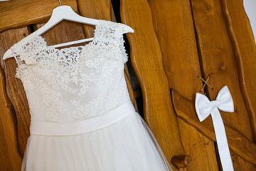 Fototapeta na wymiar Beautiful wedding dress hanged on wooden door