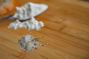 flour in spoon on wooden table