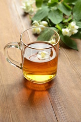 Green tea with jasmine blossom, vertical, copy space