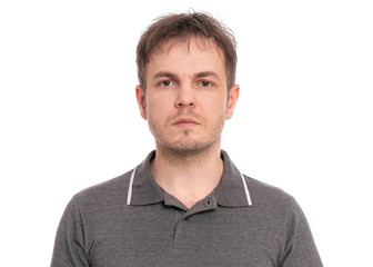 Closeup portrait of caucasian handsome Serious Man. Head shot confident guy wearing gray T-shirt, isolated on white background. 