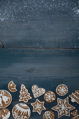 Christmas gingerbread on a blue wooden table decorated with branches of spruce. A Symbol Of Christmas. Festive food. The gingerbread man. Table decoration for the holiday. Christmas card. Empty space