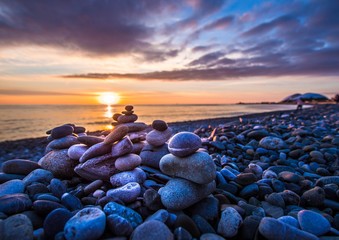 stones on the beach at sunset - 257634227