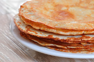 Juicy ruddy hot flavored pancakes with strawberry jam - an amazing dessert.