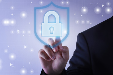 Businessman touching shield protection icon on virtual screen
