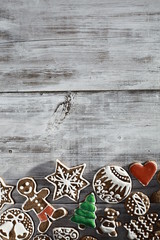 Christmas gingerbread on a light wooden table. A Symbol Of Christmas. Festive food. Delicious cookies and gingerbread. The gingerbread man. Table decoration for the holiday.