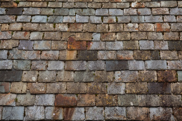 Old slate roof tiles on a building in the Welsh fishing port of Tenby in South Wales, UK