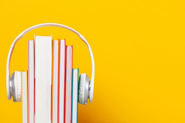 Group of books with the earphones. Audiobooks concept