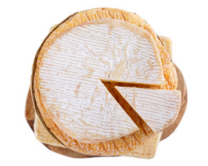 Stack of soft French cow's milk cheese on a cutting board, isolated on white, top view. Camembert, Livarote, Pont-L'eveque cheese from Normandy.